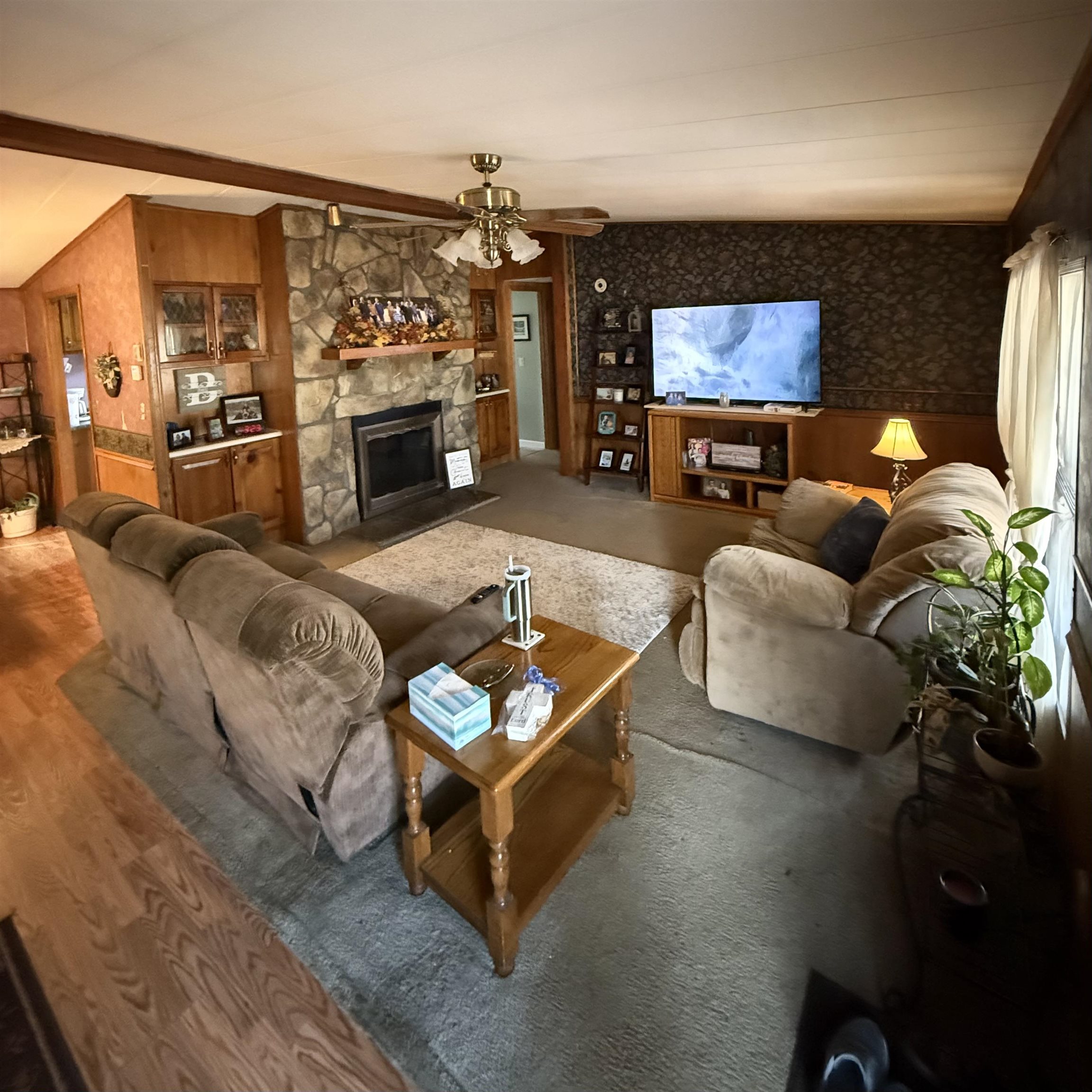 1595 Kelly Road Holladay, TN 38341 - Photo 2 of 15 a living room with furniture a flat screen tv and a fireplace