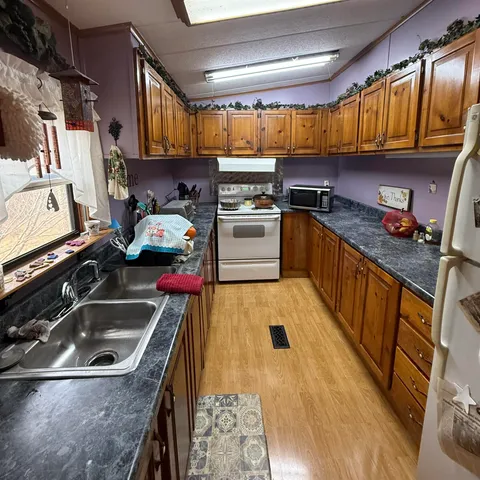 a kitchen with a sink a stove and a refrigerator