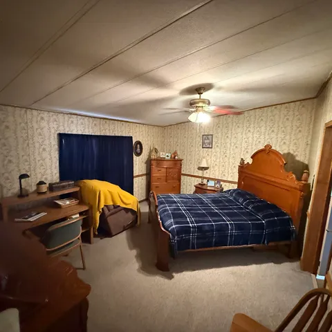 a living room with furniture gym equipment and a chandelier