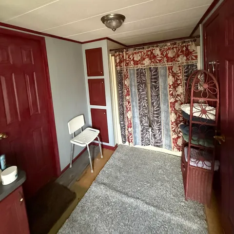 a view of a room with shelves and furniture