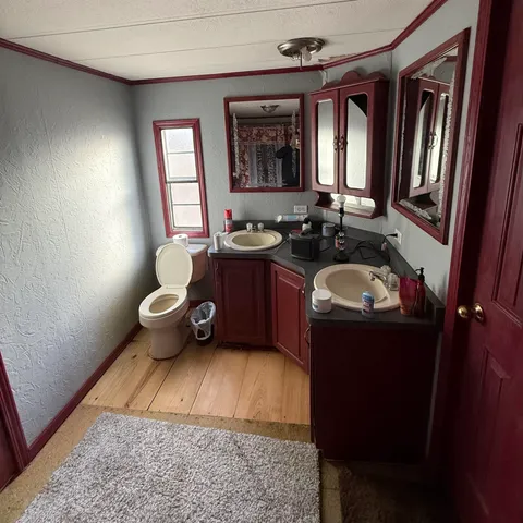 a bathroom with a tub sink toilet and mirror