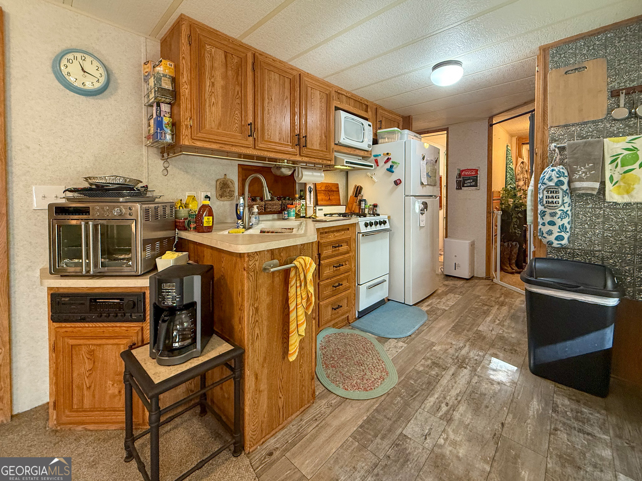 61 Rocky Lane Cleveland, GA 30528 - Photo 10 of 20 a utility room with stainless steel appliances granite countertop a stove and a refrigerator