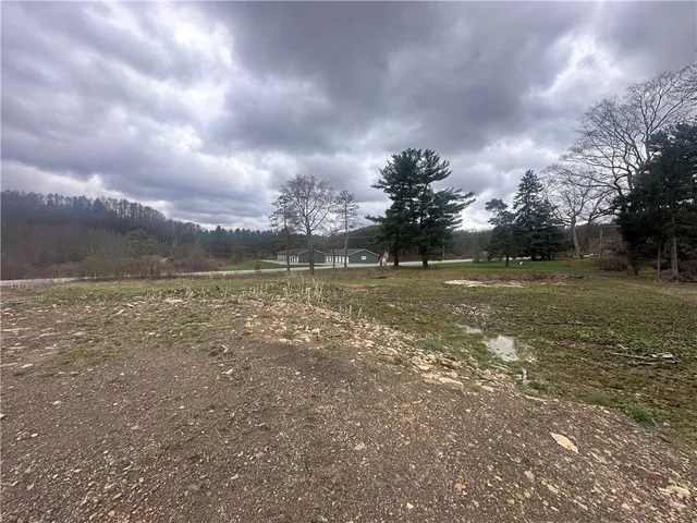 a view of a lake with houses in the back