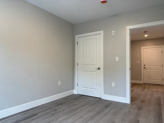a view of an empty room and wooden floor