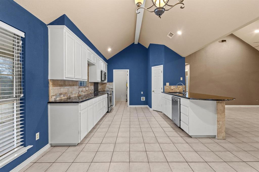 265 Cooks Corner Road Pottsboro, TX 75076 - Photo 11 of 40 a kitchen with granite countertop a sink and cabinets