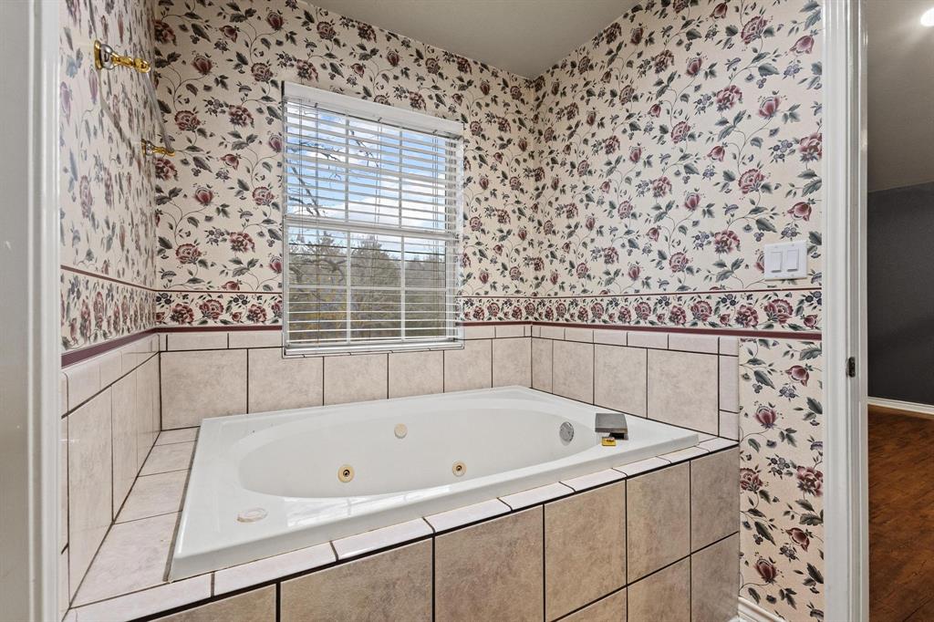 265 Cooks Corner Road Pottsboro, TX 75076 - Photo 14 of 40 a bathroom with a bathtub and shower