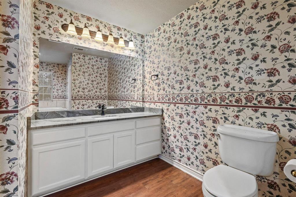 265 Cooks Corner Road Pottsboro, TX 75076 - Photo 15 of 40 a bathroom with a granite countertop toilet and a sink