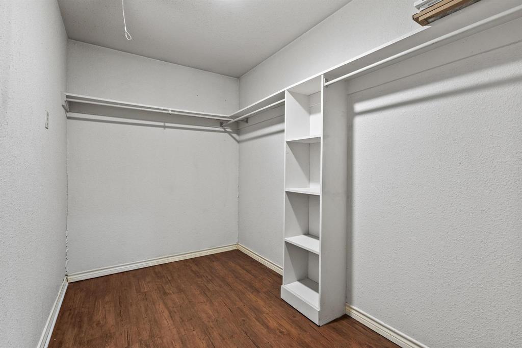 265 Cooks Corner Road Pottsboro, TX 75076 - Photo 17 of 40 a view of walk in closet with wooden floor