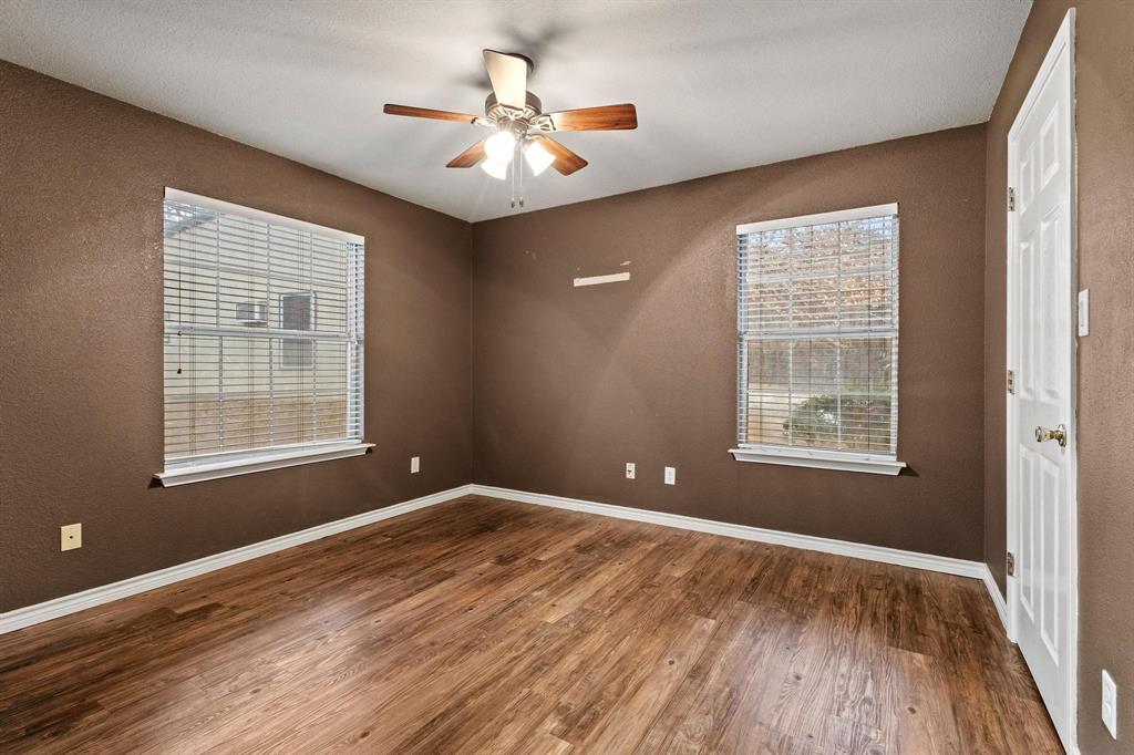 265 Cooks Corner Road Pottsboro, TX 75076 - Photo 18 of 40 a view of an empty room with a window and wooden floor