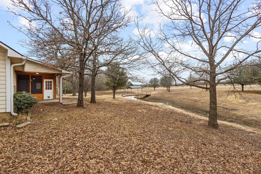 265 Cooks Corner Road Pottsboro, TX 75076 - Photo 28 of 40 a view of a yard covered with snow in front of house