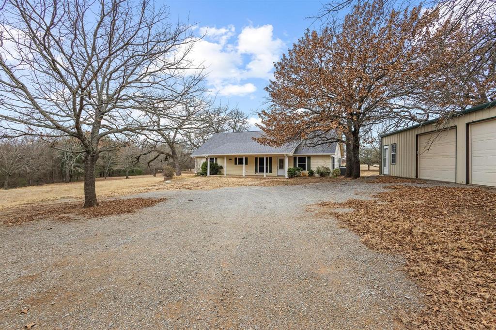 265 Cooks Corner Road Pottsboro, TX 75076 - Photo 7 of 40 a front view of a house with a yard and trees