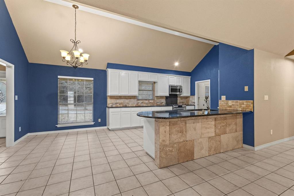 265 Cooks Corner Road Pottsboro, TX 75076 - Photo 10 of 40 a kitchen with stainless steel appliances granite countertop a sink window and cabinets