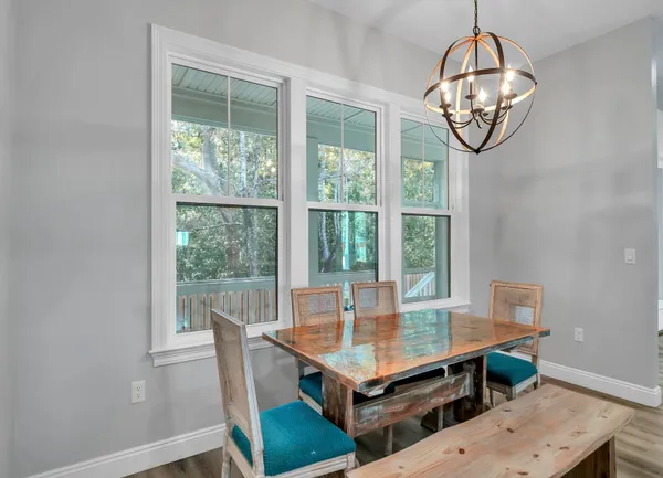a view of a dining room with furniture window and wooden floor