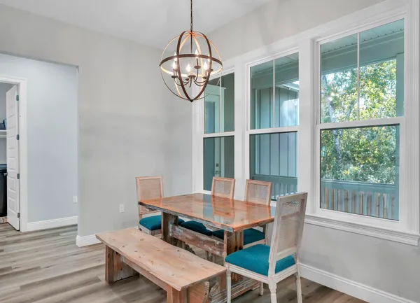 a view of a dining room with furniture window and wooden floor