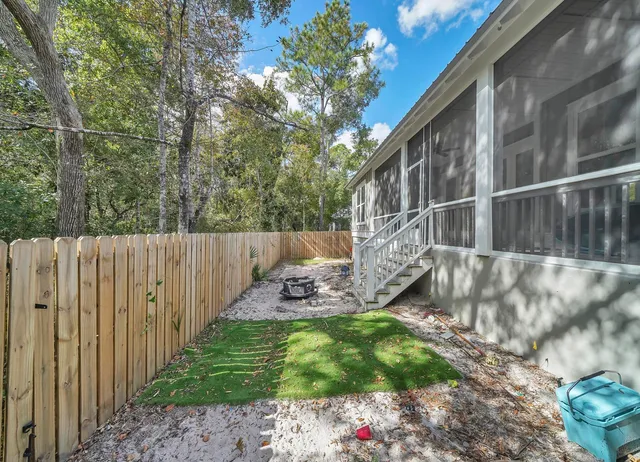 a view of yard with wooden fence