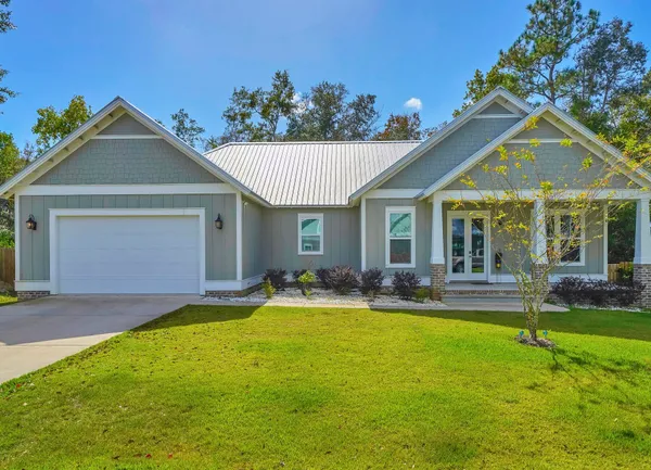 a front view of a house with a yard and porch