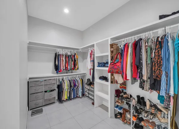 a view of walk in closet with clothes
