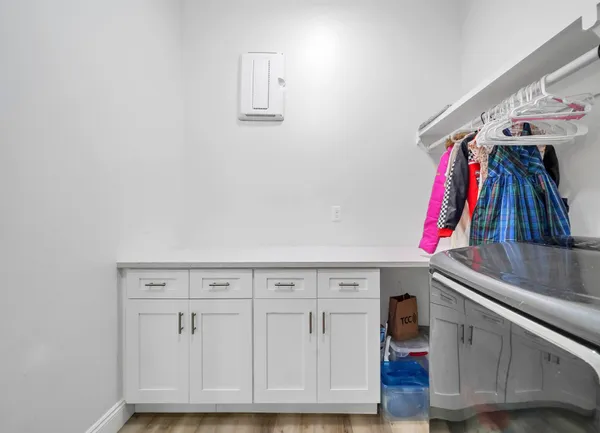 a view of walk in closet with clothes and shoes