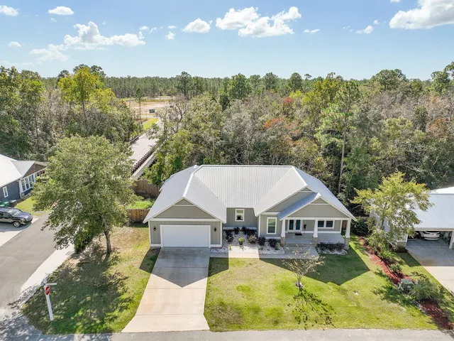 an aerial view of a house with swimming pool and mountains