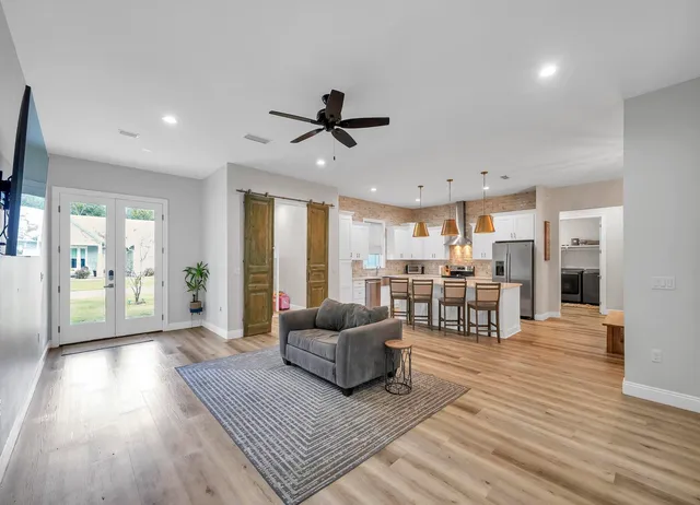 a living room with furniture and wooden floor