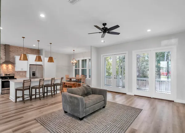 a living room with furniture and a wooden floor
