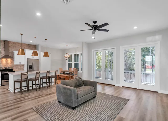 a living room with furniture and a wooden floor