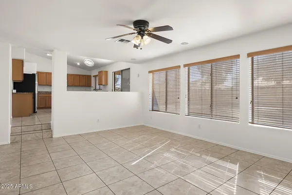 a view of a livingroom with a ceiling fan and window