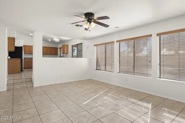 a view of a livingroom with a ceiling fan and window