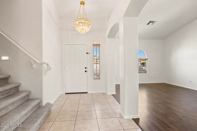 a view of a room with wooden floor and entryway