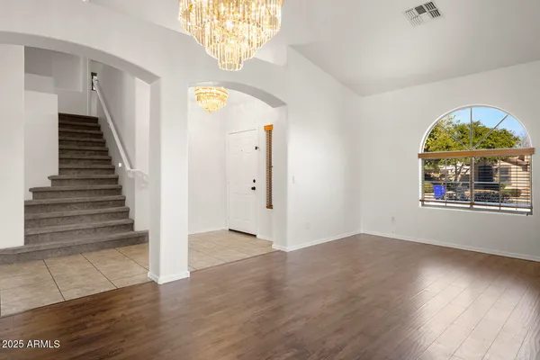 a kitchen with granite countertop a stove top oven a sink a counter top space and cabinets