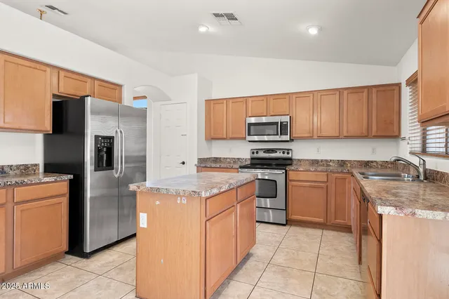 a view of a kitchen with electric appliances