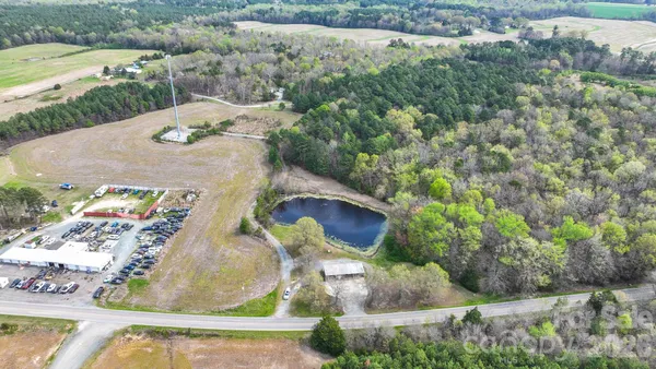 an aerial view of a house with a yard and lake view