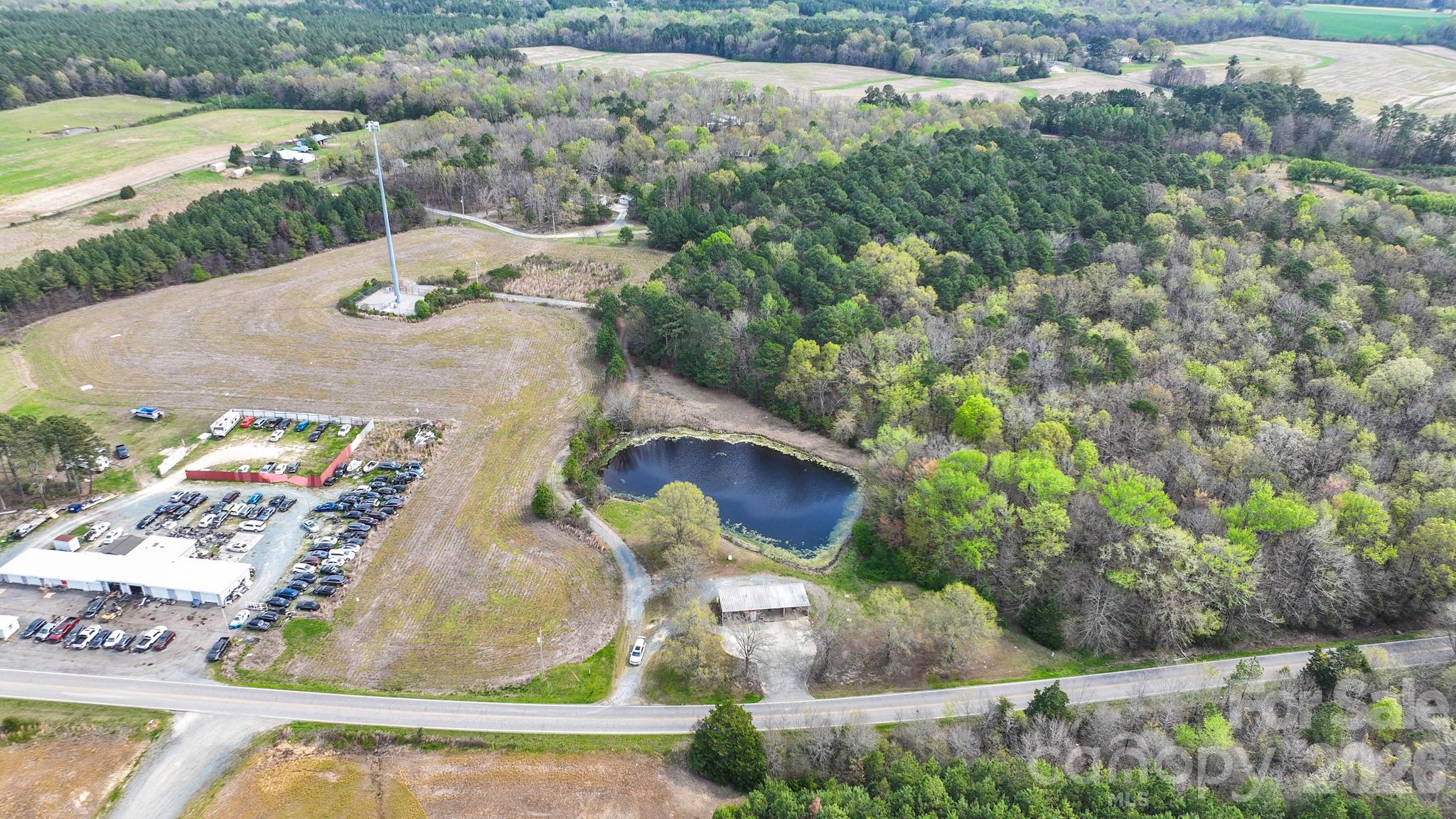 an aerial view of a house with a yard and lake view