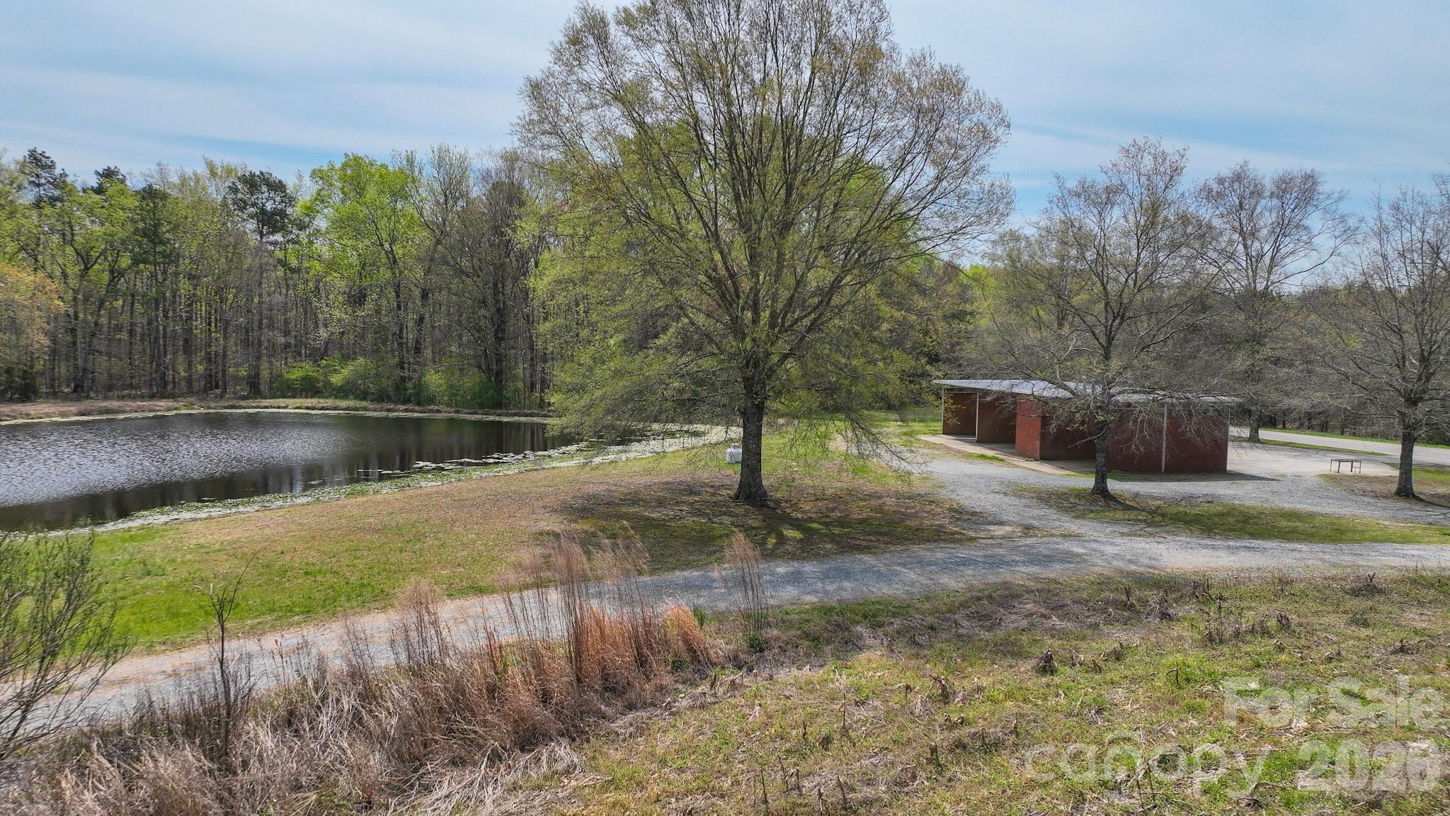 7301 Wolf Pond Road Monroe, NC 28112 - Photo 13 of 14 a backyard of a house with lots of green space