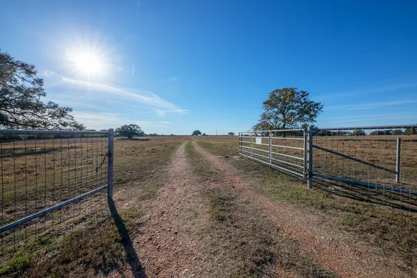 a view of a pathway with a wrought fence