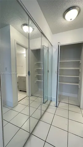 a bathroom with a shower and closet