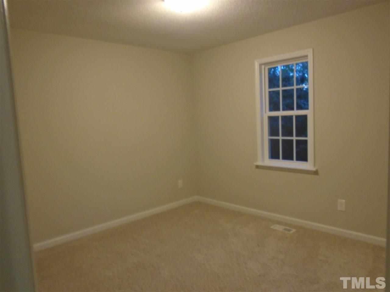 4004 Rockside Hills Drive Raleigh, NC 27603 - Photo 12 of 14 an empty room with a window