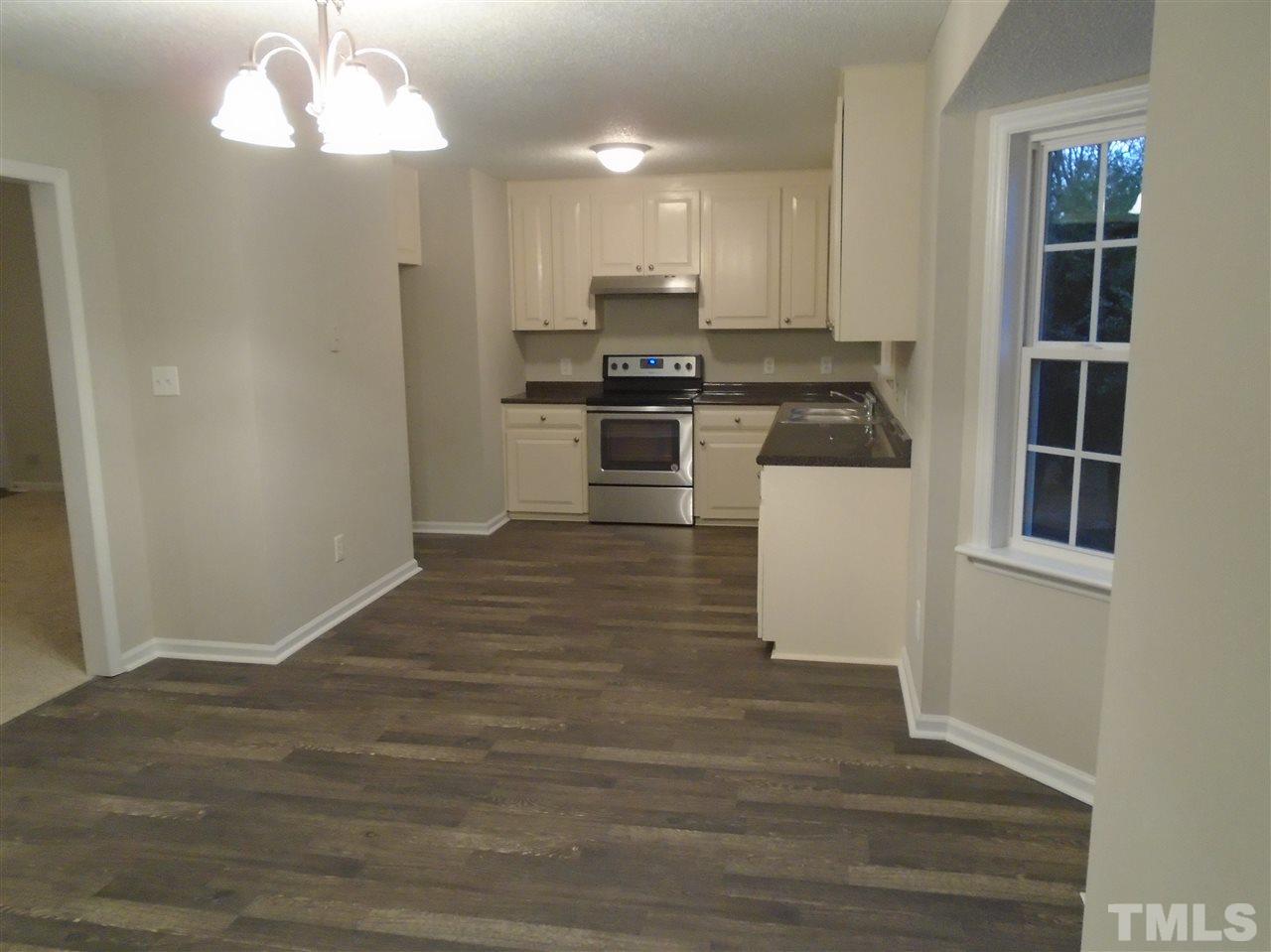 4004 Rockside Hills Drive Raleigh, NC 27603 - Photo 13 of 14 a kitchen with granite countertop a refrigerator and a stove