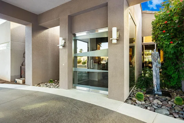 a living room with furniture a fireplace and kitchen view