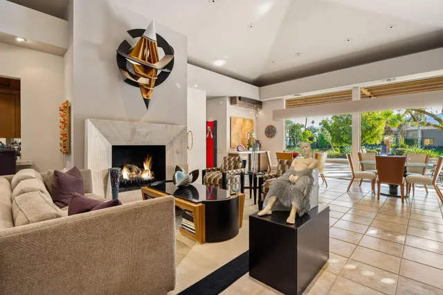 a dining room with furniture a rug and a floor to ceiling window
