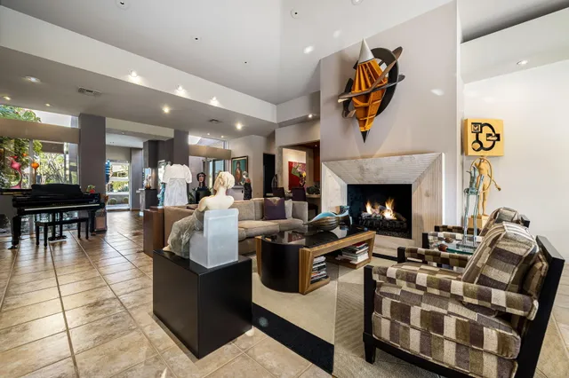 a living room with furniture white walls and a view of kitchen