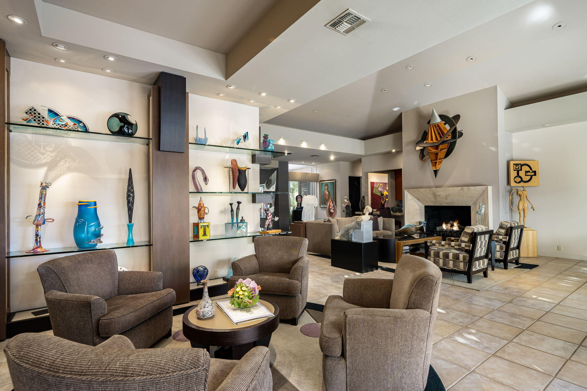 206 Crystal Bay Court Rancho Mirage, CA 92270 - Photo 26 of 62 a living room with furniture kitchen view and a fireplace