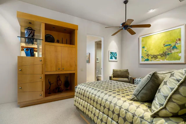 a living room with fireplace furniture and a large window