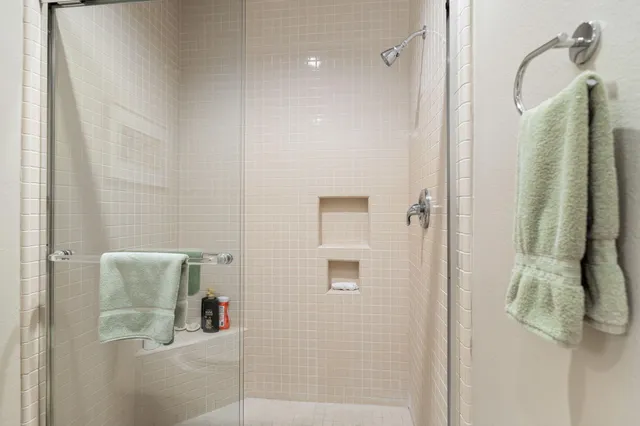 a living room with furniture a fireplace and a floor to ceiling window