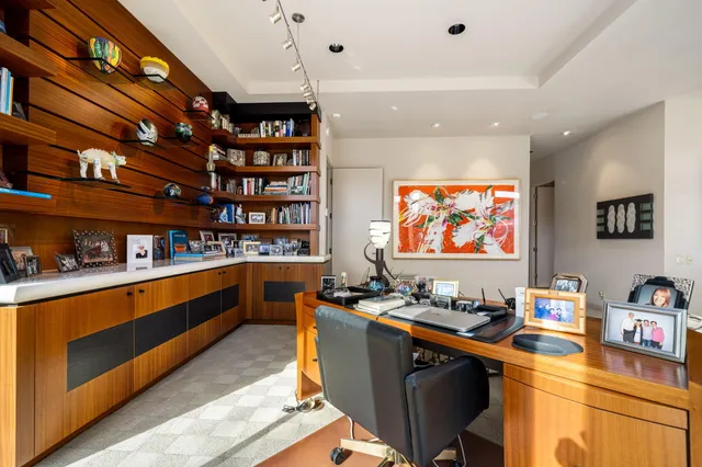 a large kitchen with kitchen island a large counter space a sink appliances and cabinets