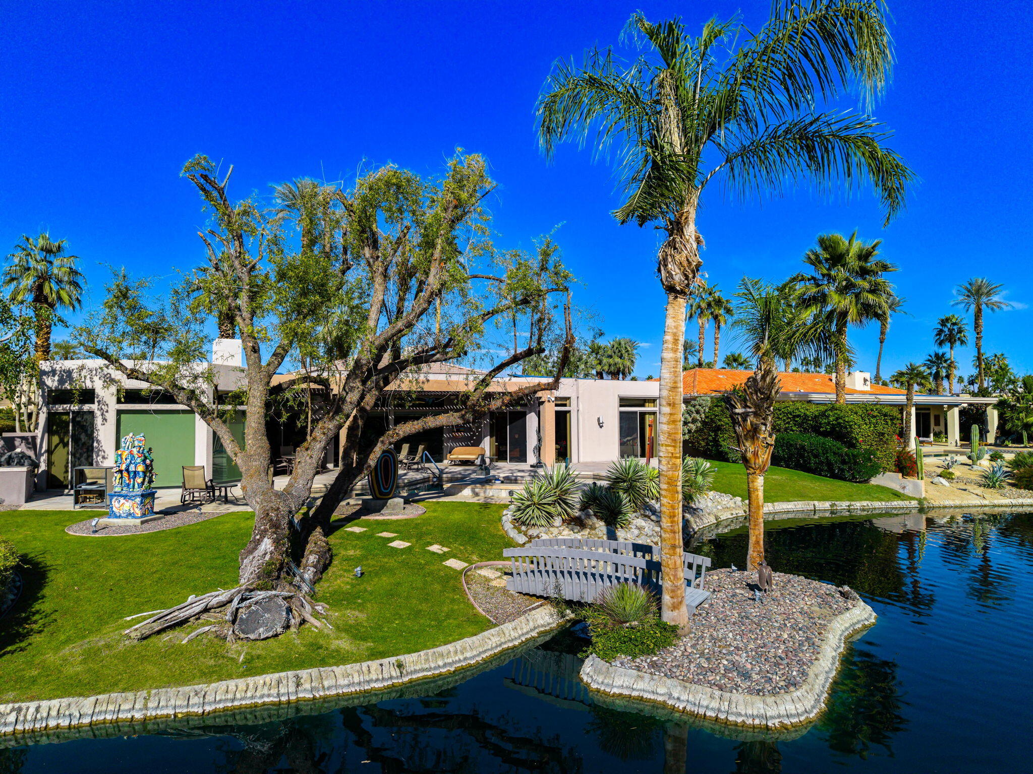 206 Crystal Bay Court Rancho Mirage, CA 92270 - Photo 10 of 62 a view of a house with swimming pool and sitting area
