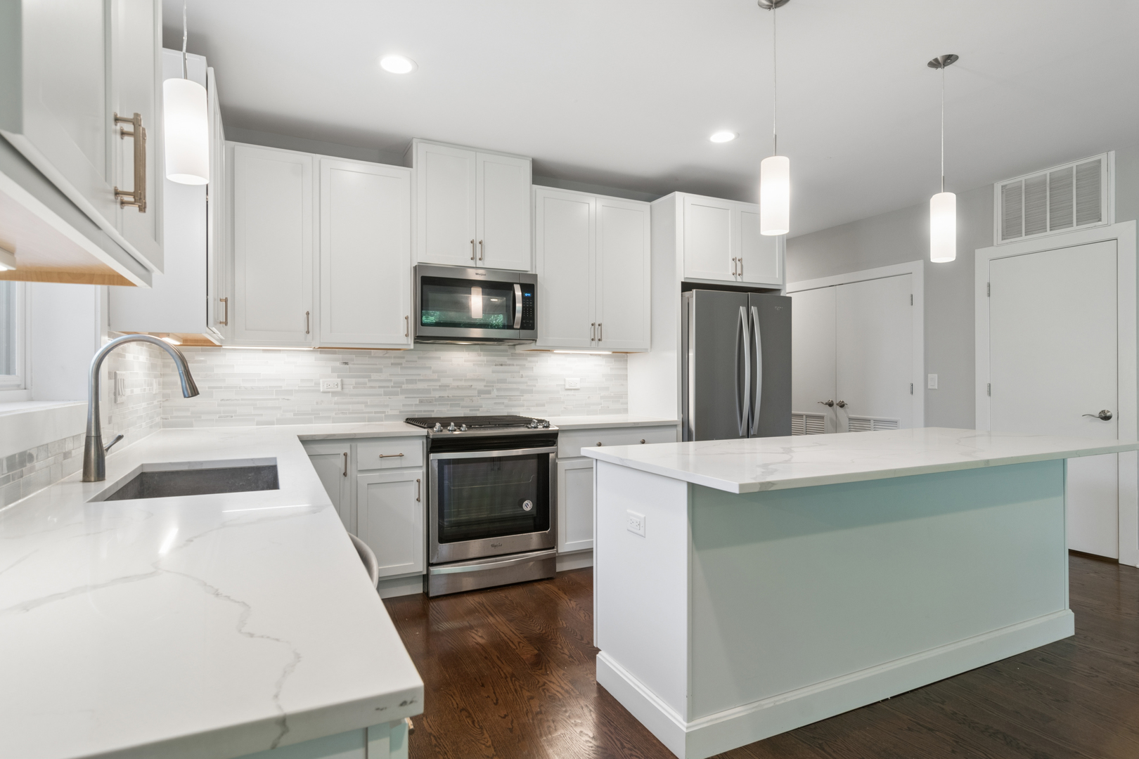 4845 North Keystone Avenue, Unit 2N Chicago, IL 60630 - Photo 7 of 21 a kitchen with kitchen island a sink stainless steel appliances and cabinets