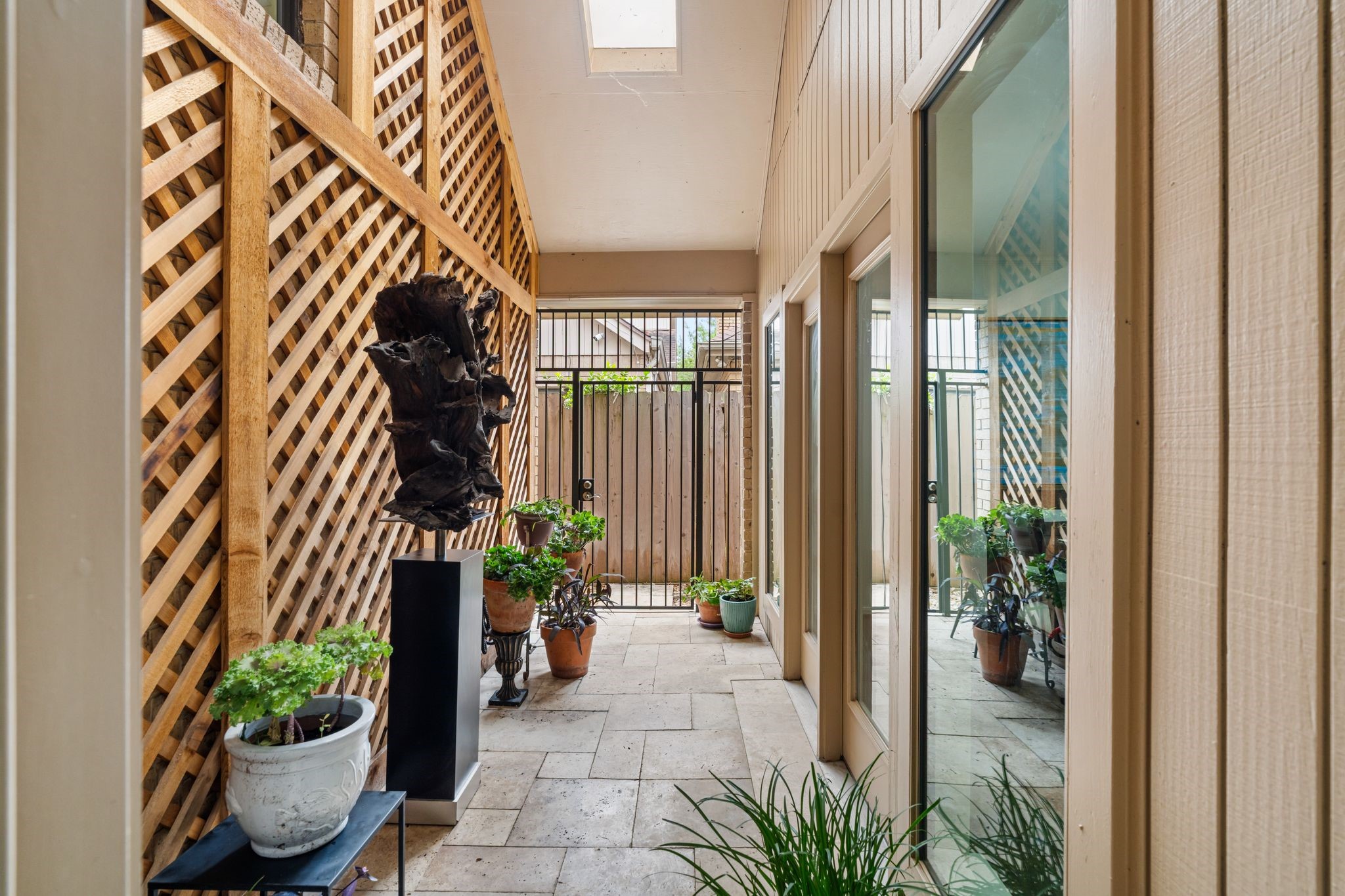 7416 Kelving Street Houston, TX 77030 - Photo 14 of 35 a potted plants sitting in front of a door with a potted plant