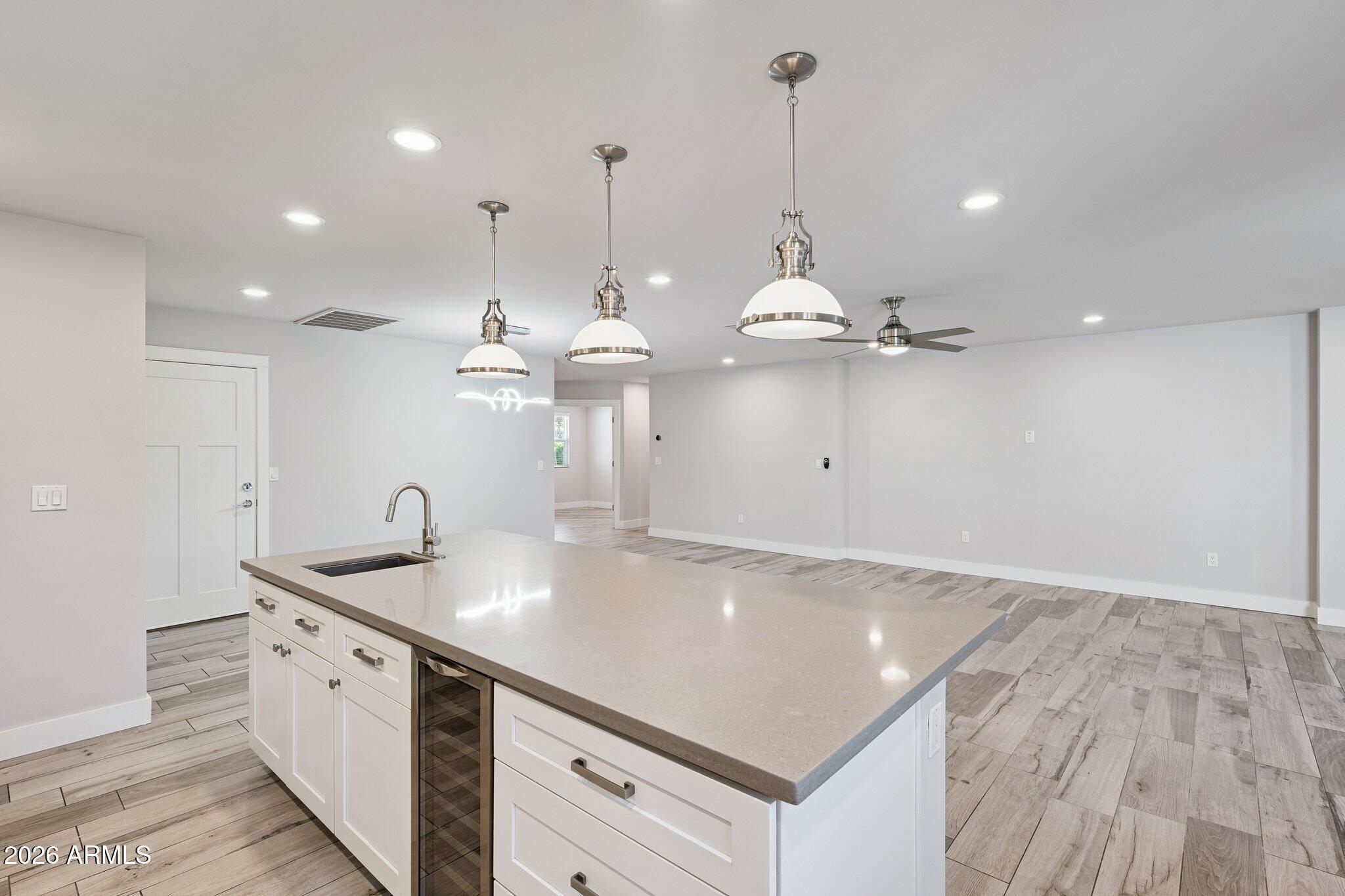 4232 North 19th Place Phoenix, AZ 85016 - Photo 12 of 39 a kitchen with kitchen island a sink stove and wooden floor
