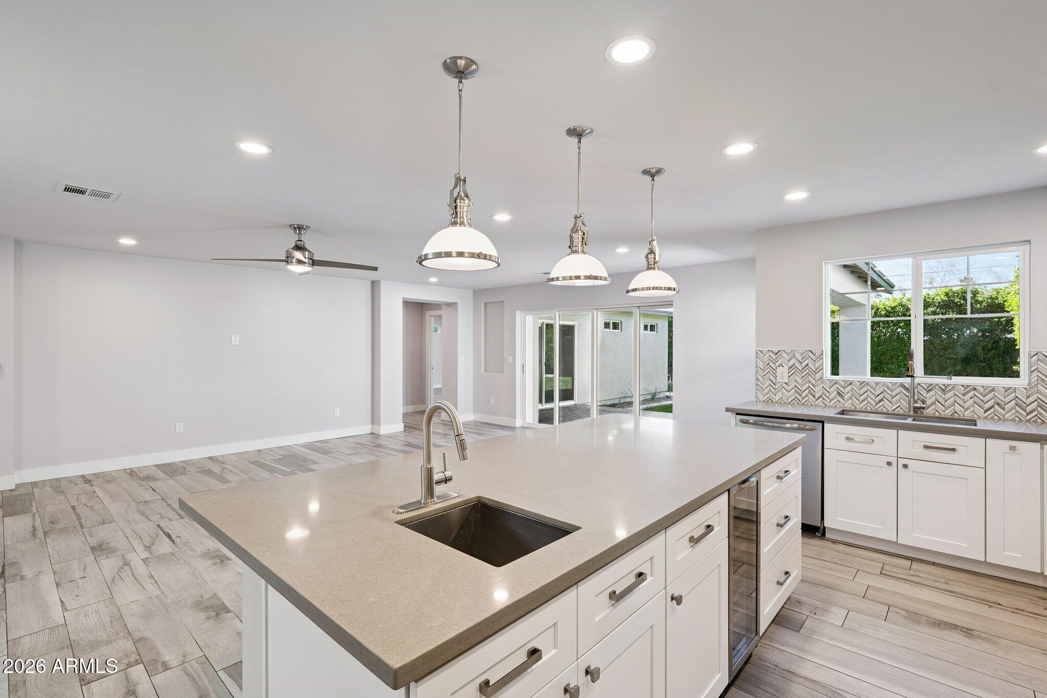4232 North 19th Place Phoenix, AZ 85016 - Photo 13 of 39 a large kitchen with kitchen island a sink counter space appliances and a window